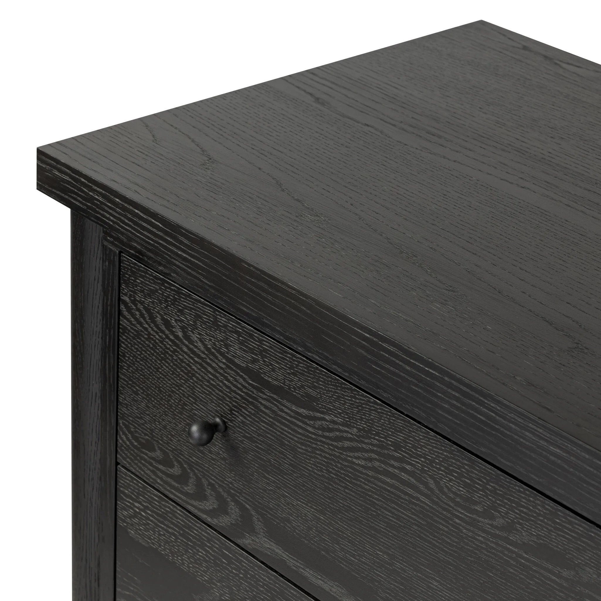 Create storage space in the bedroom with a five-drawer dresser of ebony-finished oak. Chunky dowel legs support a tall silhouette and overhang top, all finished out with simple gunmetal hardware Amethyst Home provides interior design, new home construction design consulting, vintage area rugs, and lighting in the Park City metro area.