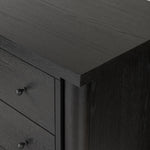 Create storage space in the bedroom with a five-drawer dresser of ebony-finished oak. Chunky dowel legs support a tall silhouette and overhang top, all finished out with simple gunmetal hardware Amethyst Home provides interior design, new home construction design consulting, vintage area rugs, and lighting in the Tampa metro area.