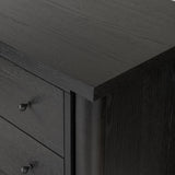 Create storage space in the bedroom with a five-drawer dresser of ebony-finished oak. Chunky dowel legs support a tall silhouette and overhang top, all finished out with simple gunmetal hardware Amethyst Home provides interior design, new home construction design consulting, vintage area rugs, and lighting in the Tampa metro area.