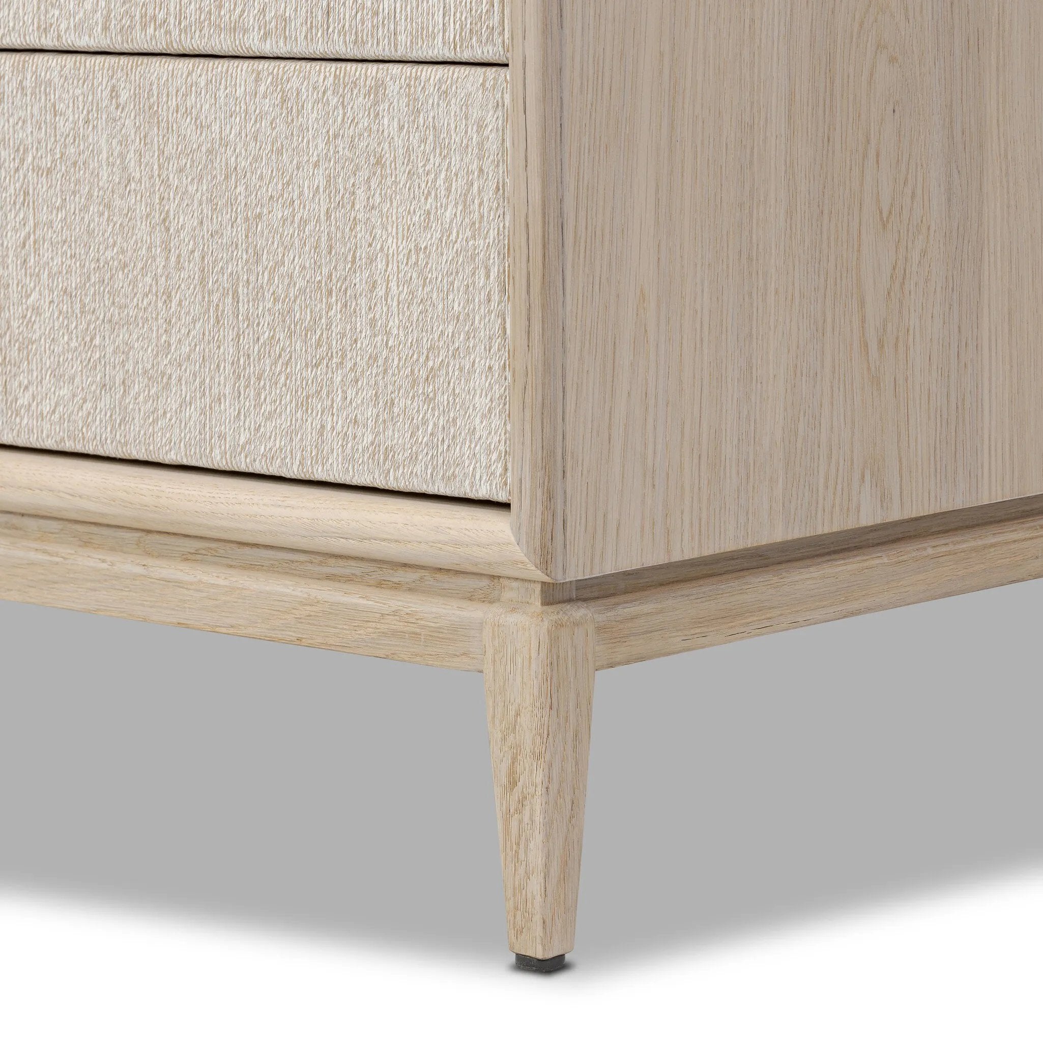 Elevate your bedroom styling with a storage-driven dresser of light, natural oak. A smooth top pairs with eight spacious drawers covered with woven paper cord. The result: a clean, Scandinavian-inspired look that will work into your collection beautifully Amethyst Home provides interior design, new home construction design consulting, vintage area rugs, and lighting in the Winter Garden metro area.