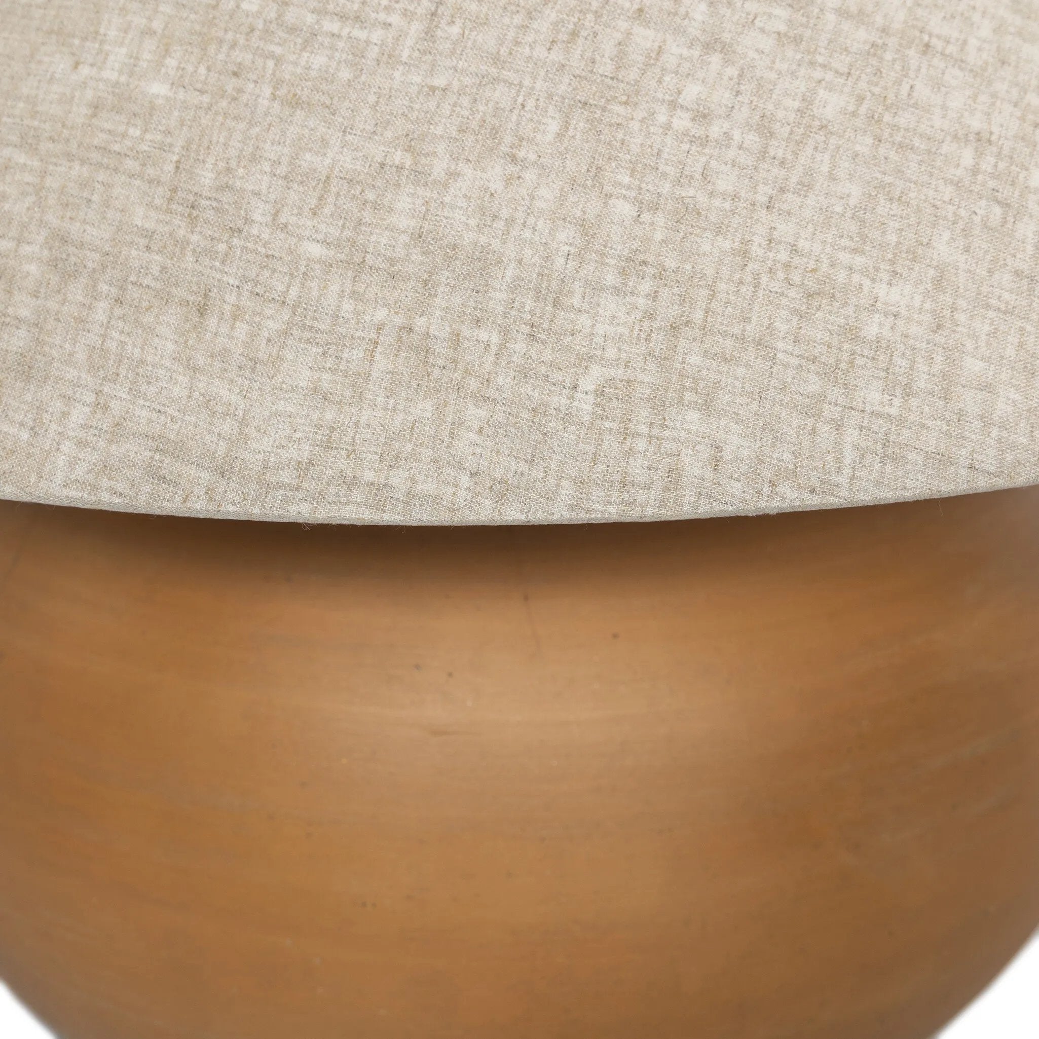 Inspired by vintage vessels, a stout table lamp bears the unique markings of natural terracotta. Topped with a neutral linen shade for texture and contrast Amethyst Home provides interior design, new home construction design consulting, vintage area rugs, and lighting in the Scottsdale metro area.