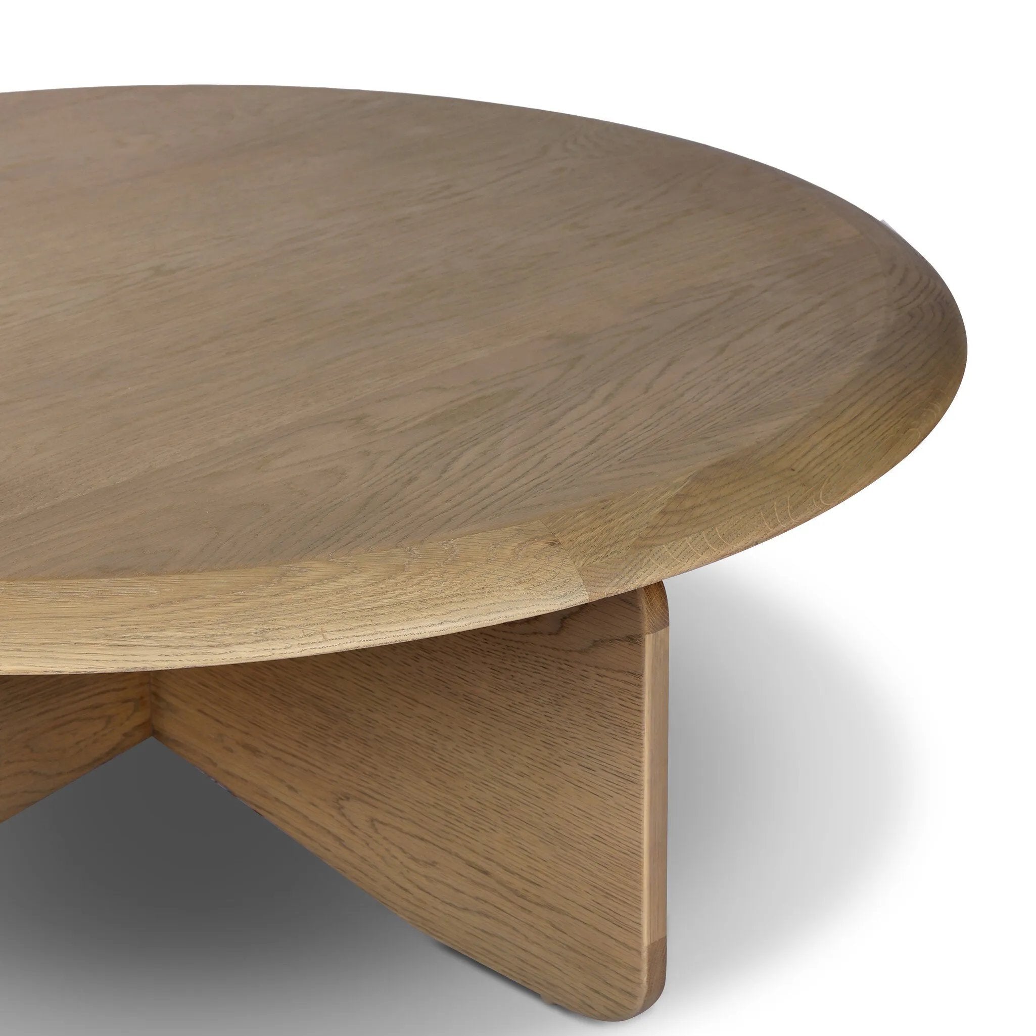 Featuring Surie Sandy Oak Resawn Coffee Table by Four Hands at Amethyst Home. A shape-driven piece inspired by clean Nordic design. Softened edges and a curved base craft a sense of flow, accentuated by cathedral grain oak with beautiful natural warmth. Overall Dimensions: 48.00"w x 48.00"d x 16.50"h. Amethyst Home provides interior design, new home construction design consulting, vintage area rugs, and lighting in the Salt Lake City metro area.