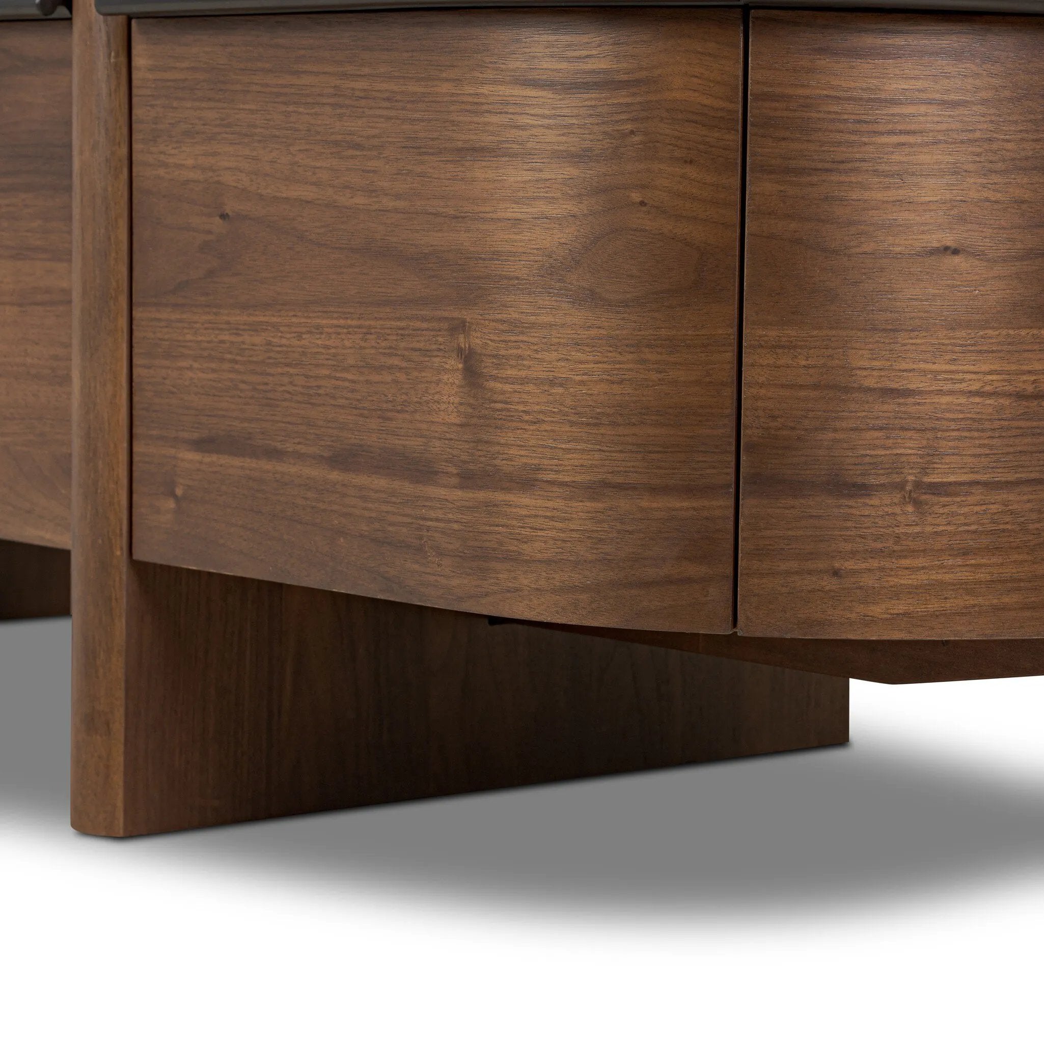 Dark brown walnut is aesthetically shaped with fluid, rounded corners on a ski leg base. The seamless design features six spacious drawers with metal bar hardware that runs along the tops of the drawers Amethyst Home provides interior design, new home construction design consulting, vintage area rugs, and lighting in the Nashville metro area.