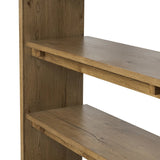 Featuring Theodore Rustic Amber Oak Veneer Bookcase by Four Hands at Amethyst Home. Wide and stately, with plenty of space for storage and display. A bookcase made from rustic amber-finished oak shapes a wide floating shelf design, with layered cross supports bringing an architectural feel to the office or living room.Overall Dimensions: 60.00"w x 18.00"d . Amethyst Home provides interior design, new home construction design consulting, vintage area rugs, and lighting in the Washington metro area.