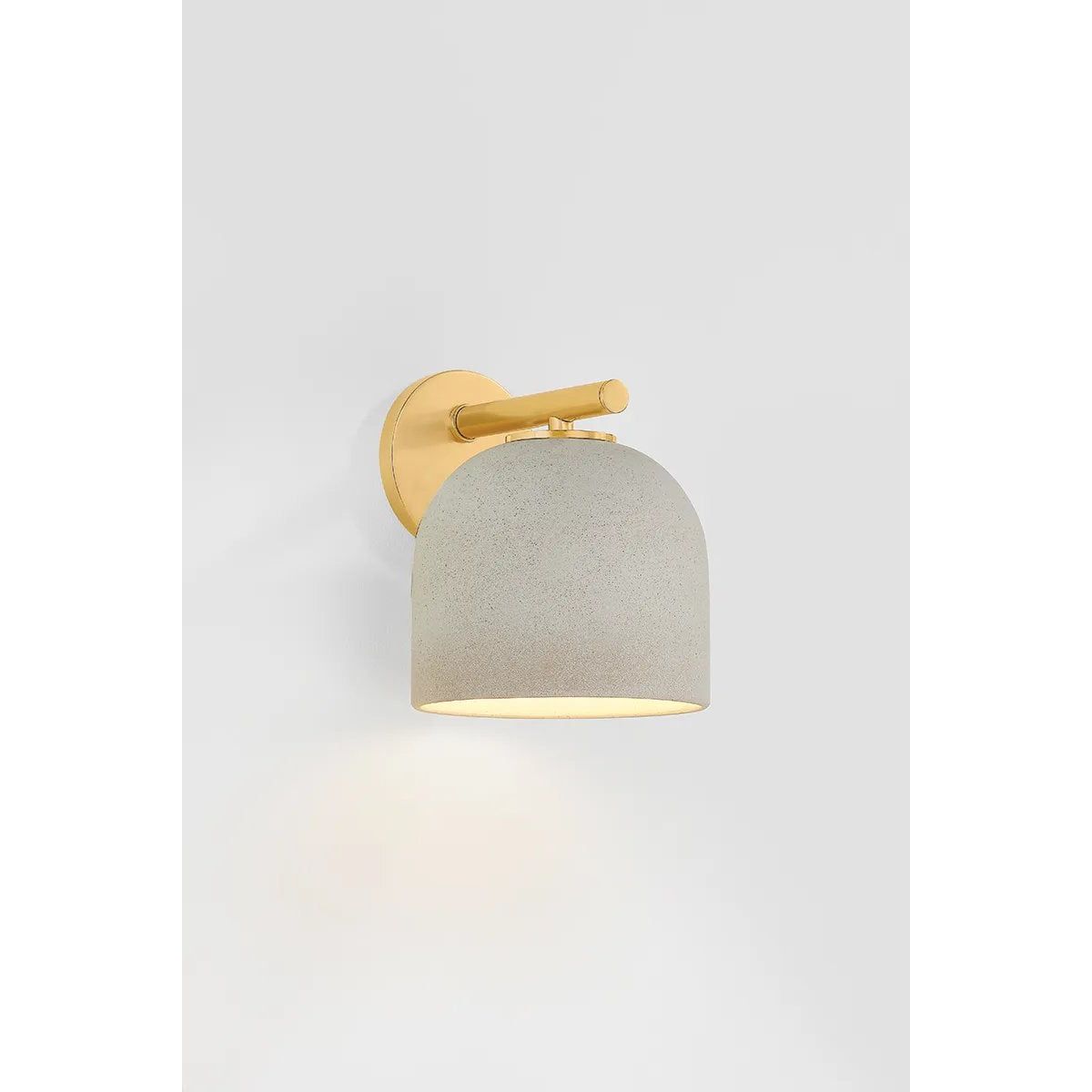 Inspired by Neoclassical architecture, Cara uses a domed shade and textural ceramic finish for a sconce that feels both ancient and new. A matte reactive glaze in an creamy hue creates a subtle surface grain that imitates natural stone. A circular modern armback in an Aged Brass finish adds shine to the fixture. Amethyst Home provides interior design, new home construction design consulting, vintage area rugs, and lighting in the Los Angeles metro area.