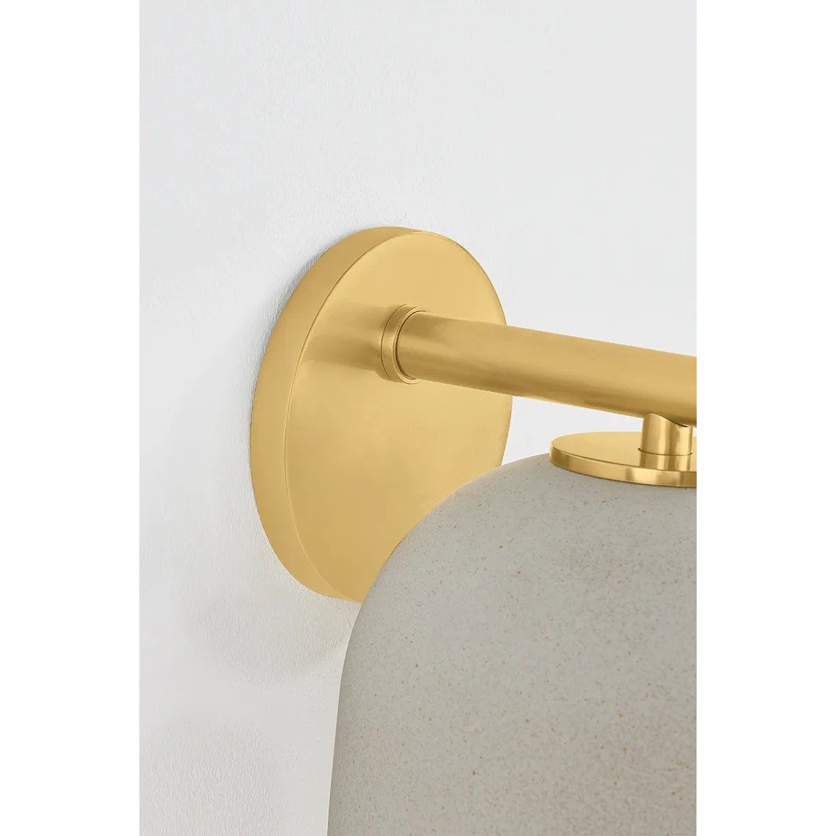 Inspired by Neoclassical architecture, Cara uses a domed shade and textural ceramic finish for a sconce that feels both ancient and new. A matte reactive glaze in an creamy hue creates a subtle surface grain that imitates natural stone. A circular modern armback in an Aged Brass finish adds shine to the fixture. Amethyst Home provides interior design, new home construction design consulting, vintage area rugs, and lighting in the Winter Garden metro area.