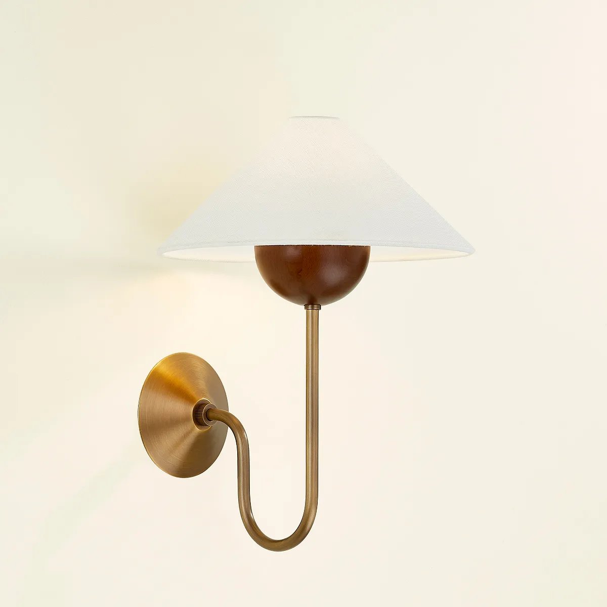 Combining geometric shapes and three distinctive earthy materials, the Evan sconce generates its own visual design language. The design-forward composition includes a swooping J-arm in Patina Brass, leading into an overscale walnut wood bobeche. As a note of contrast, the fixture is topped by a sharply tapered shade made from grained white linen. Amethyst Home provides interior design, new home construction design consulting, vintage area rugs, and lighting in the Scottsdale metro area.