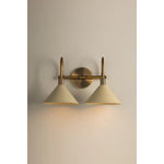 A modern interpretation of Art Deco shapes, the Jovani bath bar features elongated arms and sharply tapered Soft Sand shades. The clean design highlights the connections between elements through pronounced fittings and subtle fluting details. Finished in classic Patina Brass, Jovani is available with 1, 2, or 3 lights. Amethyst Home provides interior design, new home construction design consulting, vintage area rugs, and lighting in the Boston metro area.