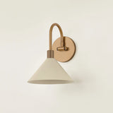 A modern interpretation of Art Deco shapes, the Jovani bath bar features elongated arms and sharply tapered Soft Sand shades. The clean design highlights the connections between elements through pronounced fittings and subtle fluting details. Finished in classic Patina Brass, Jovani is available with 1, 2, or 3 lights. Amethyst Home provides interior design, new home construction design consulting, vintage area rugs, and lighting in the Houston metro area.