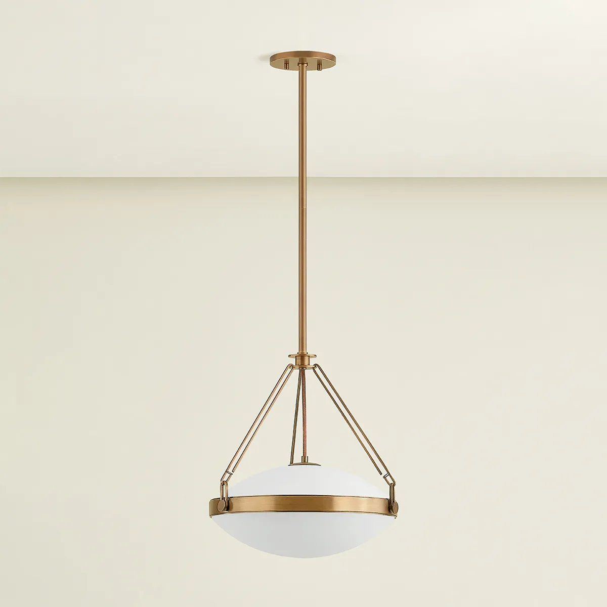 The Kade pendant updates a nostalgic shape with sleek, industrial metalwork and two large opal matte glass shades. Inspired by vintage elements, it features a striking suspension technique with three oversized loops connecting to the central housing above the fixture. The Patina Brass finish adds old-world finesse to the frame. Amethyst Home provides interior design, new home construction design consulting, vintage area rugs, and lighting in the Scottsdale metro area.