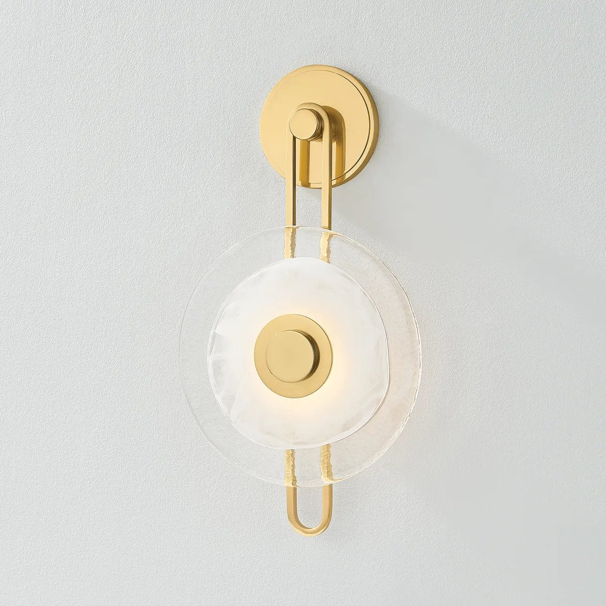 The earring-like design of Keuka Park exudes ornamental, graphic appeal. A thick disc of Blonchino Piastre glass is illuminated at the point where it attaches to the racetrack frame of this striking wall fixture. Whether finished in Aged Brass or Old Bronze, Keuka Park brings modernist artistry to any wall. Amethyst Home provides interior design, new home construction design consulting, vintage area rugs, and lighting in the Calabasas metro area.
