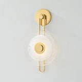 The earring-like design of Keuka Park exudes ornamental, graphic appeal. A thick disc of Blonchino Piastre glass is illuminated at the point where it attaches to the racetrack frame of this striking wall fixture. Whether finished in Aged Brass or Old Bronze, Keuka Park brings modernist artistry to any wall. Amethyst Home provides interior design, new home construction design consulting, vintage area rugs, and lighting in the Calabasas metro area.
