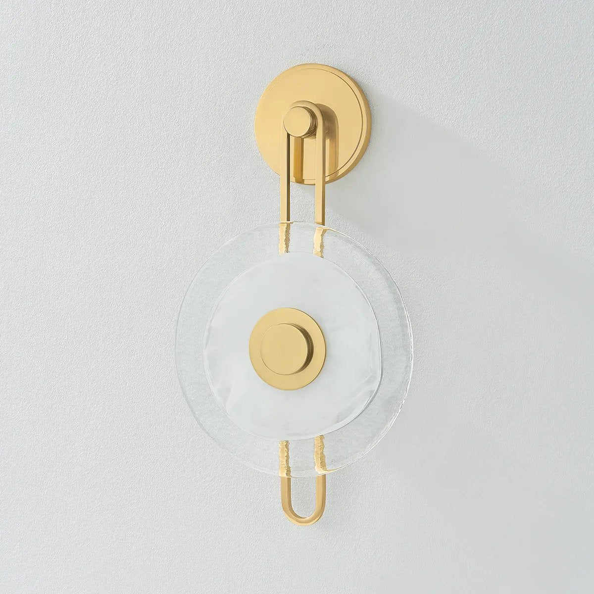 The earring-like design of Keuka Park exudes ornamental, graphic appeal. A thick disc of Blonchino Piastre glass is illuminated at the point where it attaches to the racetrack frame of this striking wall fixture. Whether finished in Aged Brass or Old Bronze, Keuka Park brings modernist artistry to any wall. Amethyst Home provides interior design, new home construction design consulting, vintage area rugs, and lighting in the Laguna Beach metro area.