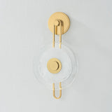 The earring-like design of Keuka Park exudes ornamental, graphic appeal. A thick disc of Blonchino Piastre glass is illuminated at the point where it attaches to the racetrack frame of this striking wall fixture. Whether finished in Aged Brass or Old Bronze, Keuka Park brings modernist artistry to any wall. Amethyst Home provides interior design, new home construction design consulting, vintage area rugs, and lighting in the Laguna Beach metro area.