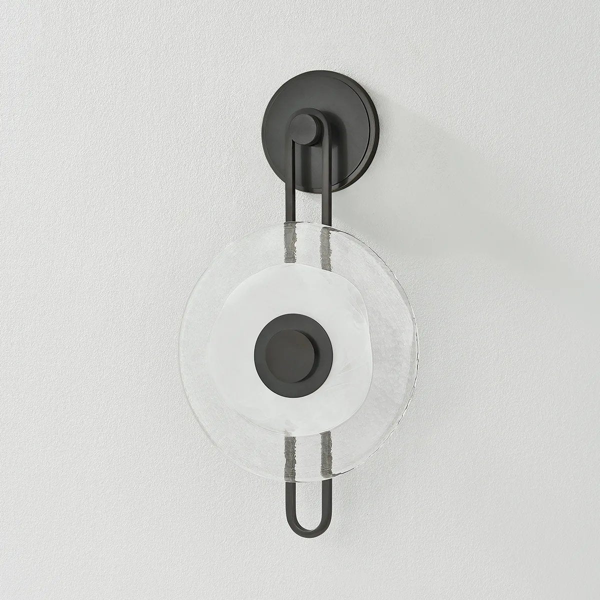 The earring-like design of Keuka Park exudes ornamental, graphic appeal. A thick disc of Blonchino Piastre glass is illuminated at the point where it attaches to the racetrack frame of this striking wall fixture. Whether finished in Aged Brass or Old Bronze, Keuka Park brings modernist artistry to any wall. Amethyst Home provides interior design, new home construction design consulting, vintage area rugs, and lighting in the Salt Lake City metro area.