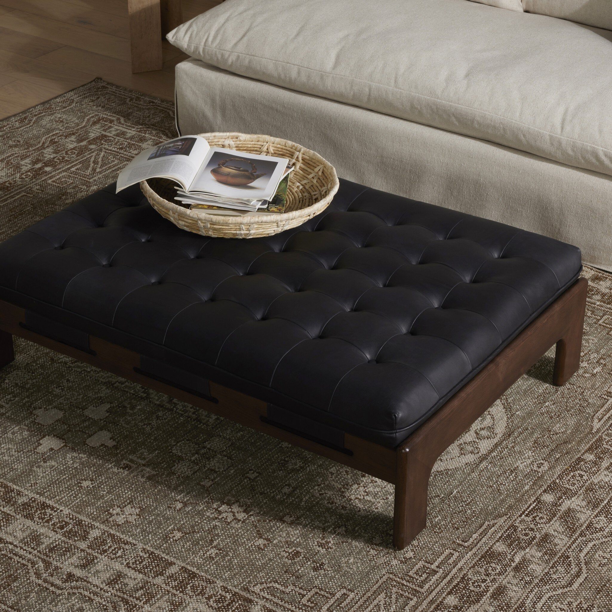 Featuring Halston Heirloom Black Cocktail Ottoman by Four Hands at Amethyst Home. A Seventies-era style inspired by a flea market find. Top-grain leather features dramatic tufting with sling detailing and wide ash framing below. Sourced from one of the oldest family-owned tanneries in Italy's Bassano del Grappa, heirloom leather is salvaged and processed from upcycled hides featuring . Amethyst Home provides interior design, new construction, custom furniture, and area rugs in the Tampa metro area