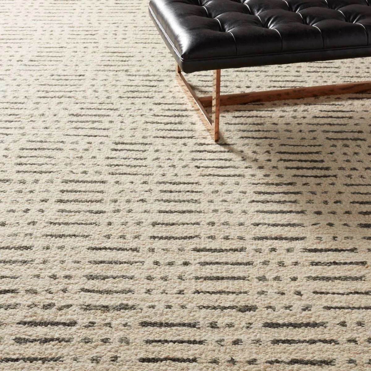 Featuring Leona  Elver Rug by Jaipur Living at Amethyst Home. The texture-rich Leona Elver offers an assortment of updated kilim looks, re-invented with the on-trend shearling style and neutral, modern palettes. The handwoven Elver rug features a globally inspired, gray dot and ticking line pattern on a neutral tan base. This 100% wool accent piece delights. Amethyst Home provides interior design, new home construction design consulting, vintage area rugs, and lighting in the Calabasas metro area.