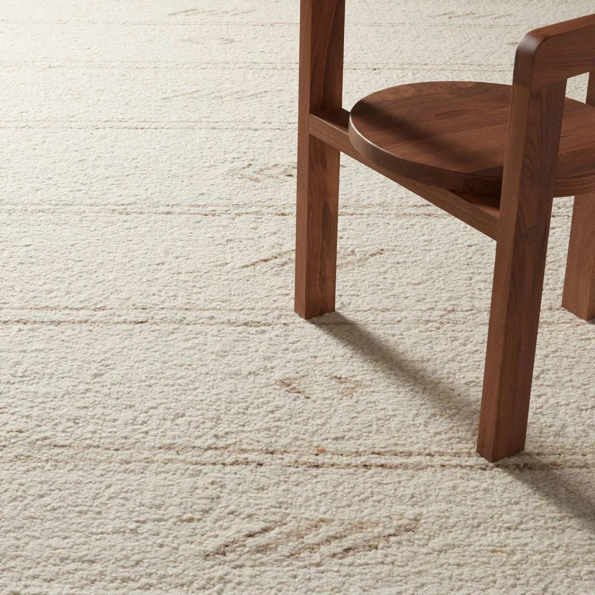 Featuring Leona  Essek Rug by Jaipur Living at Amethyst Home. The texture-rich Leona Essek offers an assortment of updated kilim looks, re-invented with the on-trend shearling style and neutral, modern palettes. The handwoven Essek rug features a globally inspired, light brown, stripe and tribal pattern on a neutral cream base. This 100% wool accent piece de. Amethyst Home provides interior design, new home construction design consulting, vintage area rugs, and lighting in the Portland metro area.