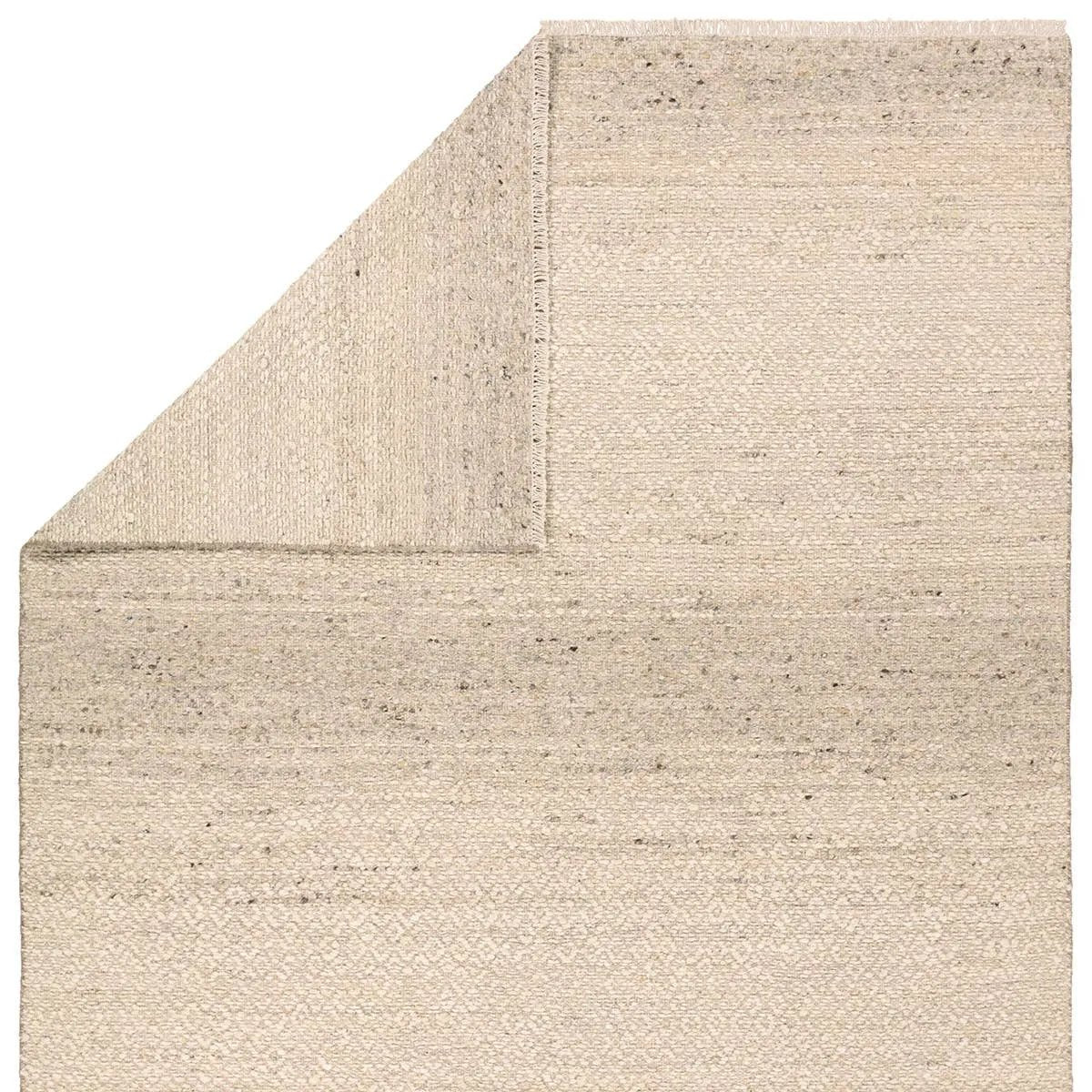 Featuring Leona Folade Rug by Jaipur Living at Amethyst Home. The texture-rich Leona Folade offers an assortment of updated kilim looks, re-invented with the on-trend shearling style and neutral, modern palettes. The handwoven Folade rug features a distressed tan base with hints of trellis beige detailing. This 100% wool accent piece delights in high and low. Amethyst Home provides interior design, new home construction design consulting, vintage area rugs, and lighting in the Monterey metro area.