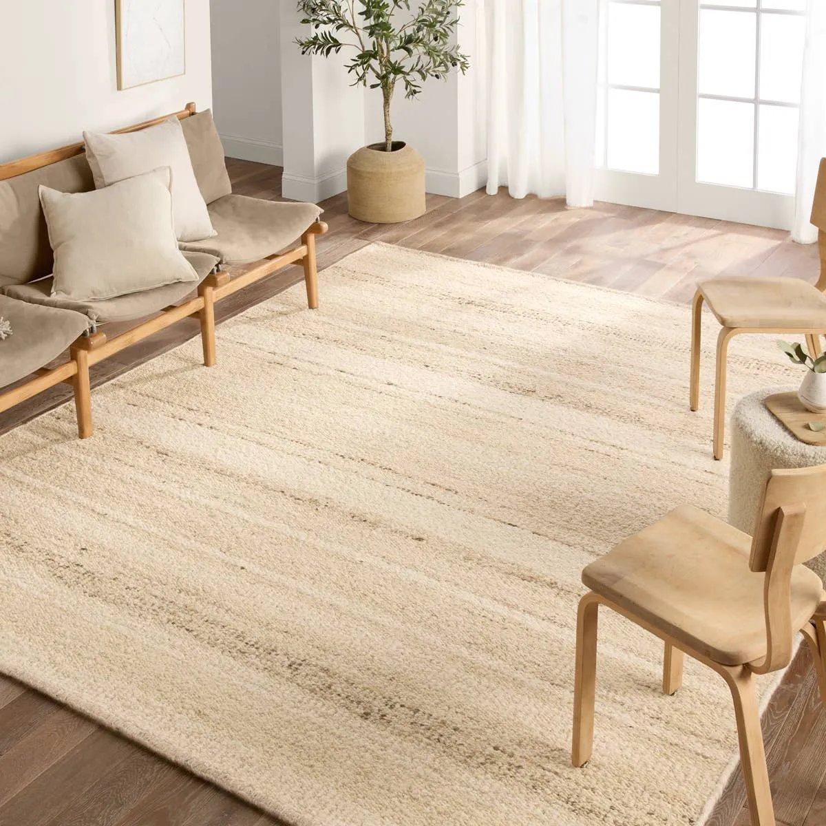Featuring Leona Sollus Rug by Jaipur Living at Amethyst Home. The texture-rich Leona Sollus offers an assortment of updated kilim looks, re-invented with the on-trend shearling style and neutral, modern palettes. The handwoven Sollus rug features a tan base with brown and beige stripes. This 100% wool accent piece delights in high and low traffic spaces su. Amethyst Home provides interior design, new home construction design consulting, vintage area rugs, and lighting in the Scottsdale metro area.