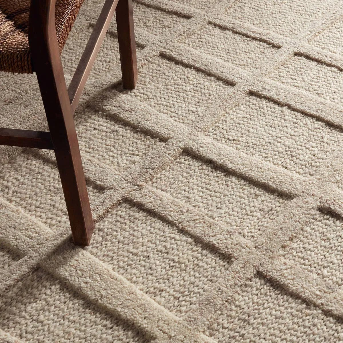 Featuring Lustrous Rug by Jaipur Living at Amethyst Home. The Lustrous design features flowing waves of 100% premium undyed wool in soft cream tones. Its high-low texture creates movement, adding an earthy, elemental ease to any modern space. Crafted with care to mimic a soumak weave, this rug offers timeless elegance and a soft, tactile feel.Hand Tufted1. Amethyst Home provides interior design, new home construction design consulting, vintage area rugs, and lighting in the Kansas City metro area.