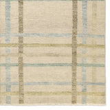 Featuring Raza Hand-Knotted Rug by Jaipur Living at Amethyst Home. The Raza design reinvents the timeless plaid pattern, fusing classic charm with a modern edge. Soft beige tones, punctuated by a blue accent, elevate any mid-century modern space. Handcrafted from naturally stain-resistant wool, this rug handles medium-traffic areas, kids, and pets with ease. Amethyst Home provides interior design, new home construction design consulting, vintage area rugs, and lighting in the Calabasas metro area.