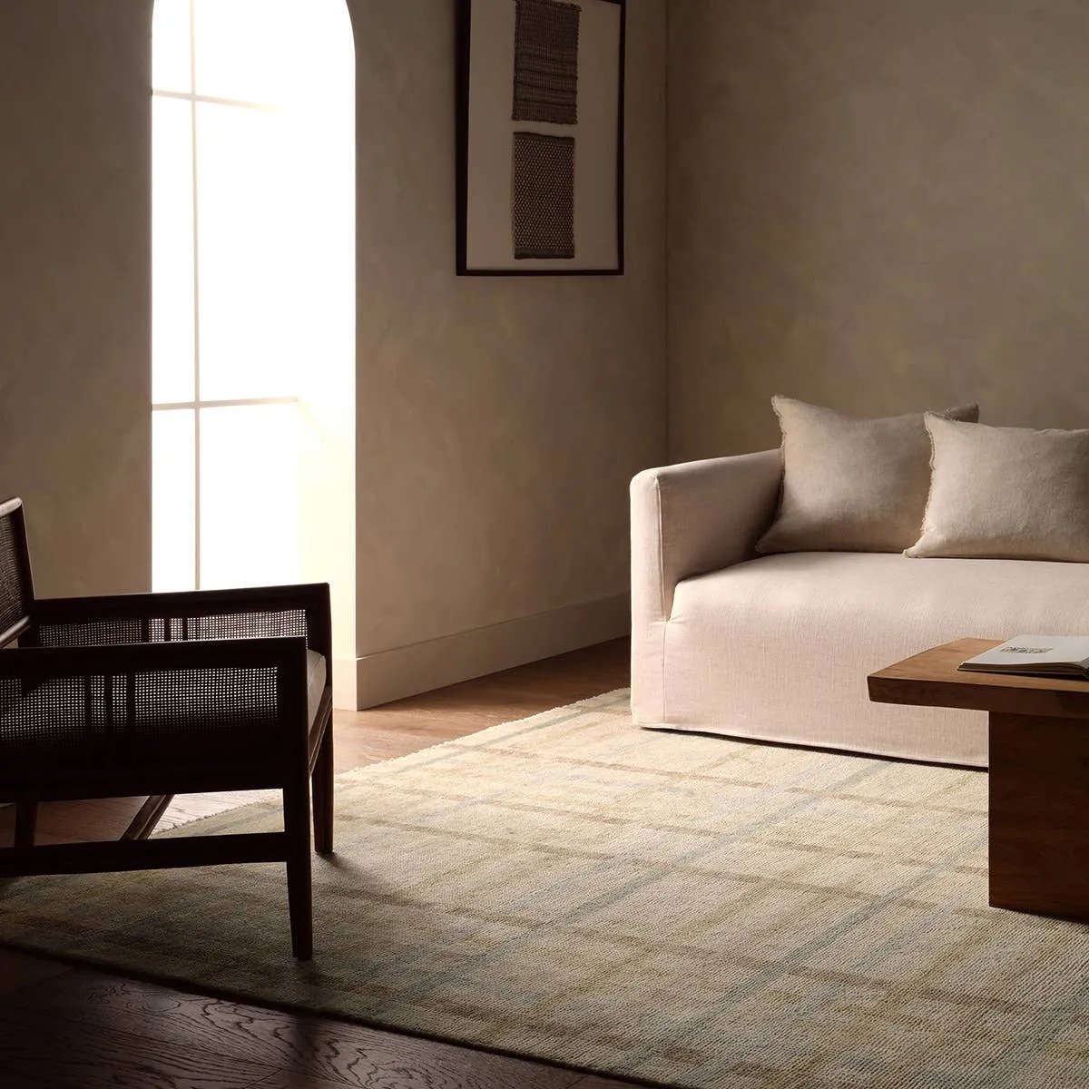 Featuring Raza Hand-Knotted Rug by Jaipur Living at Amethyst Home. The Raza design reinvents the timeless plaid pattern, fusing classic charm with a modern edge. Soft beige tones, punctuated by a blue accent, elevate any mid-century modern space. Handcrafted from naturally stain-resistant wool, this rug handles medium-traffic areas, kids, and pets with ease. Amethyst Home provides interior design, new home construction design consulting, vintage area rugs, and lighting in the Charlotte metro area.