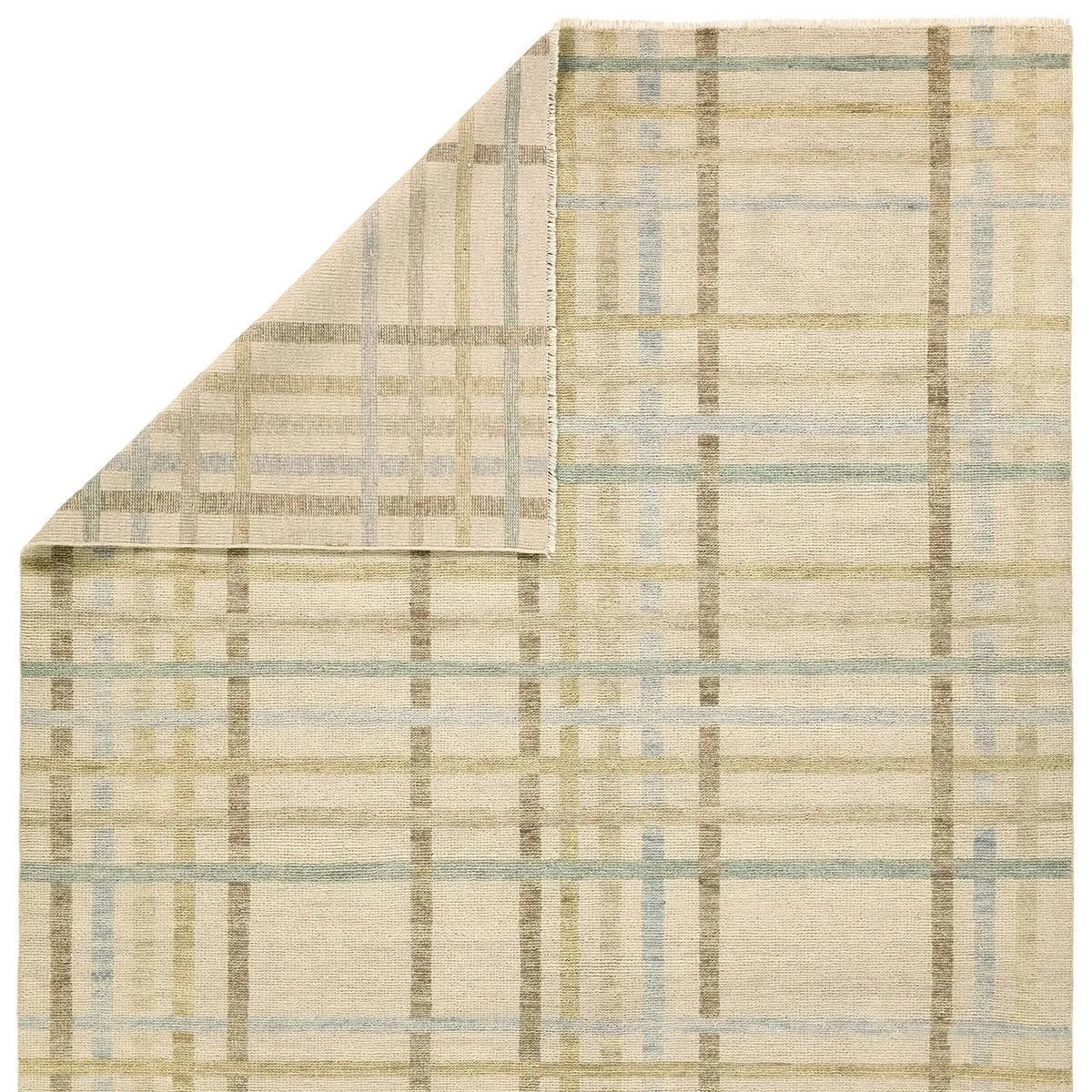 Featuring Raza Hand-Knotted Rug by Jaipur Living at Amethyst Home. The Raza design reinvents the timeless plaid pattern, fusing classic charm with a modern edge. Soft beige tones, punctuated by a blue accent, elevate any mid-century modern space. Handcrafted from naturally stain-resistant wool, this rug handles medium-traffic areas, kids, and pets with eas. Amethyst Home provides interior design, new home construction design consulting, vintage area rugs, and lighting in the Scottsdale metro area.