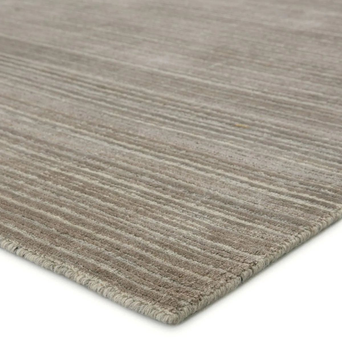 Featuring Second Sunset  Gradient Rug by Jaipur Living at Amethyst Home. The easy-to-decorate, earthy tones of the Second Sunset Gradient prove that simplicity can sometimes be striking. The Gradient rug is hand loomed of durable wool and jasmine for a sumptuous and inviting hand. The variation in the cool brown, gray, and light taupe tones of this lustrous. Amethyst Home provides interior design, new home construction design consulting, vintage area rugs, and lighting in the Charlotte metro area.