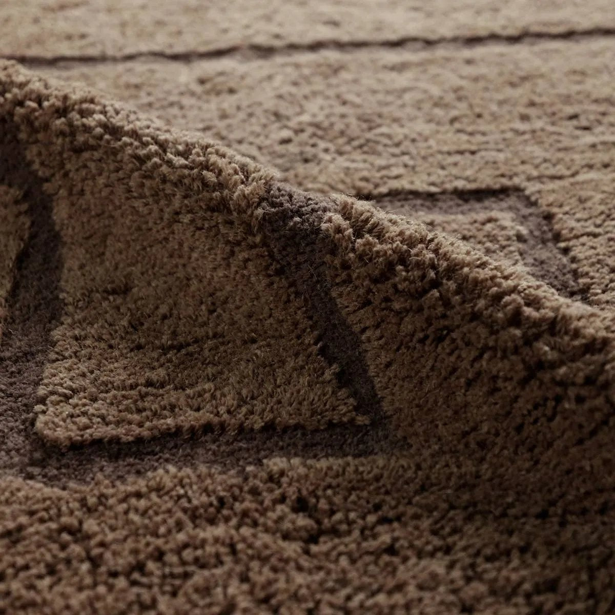 Featuring Ziyan Rug by Jaipur Living at Amethyst Home. With its neutral brown hue and modern geometric pattern, the Aibel Ziyan adds a contemporary touch to your space. Hand-tufted from washable wool and offering plush comfort, it’s ideal for kids’ rooms or any area where spills are bound to happen. Here’s a stylish, worry-free solution that can handle the dem. Amethyst Home provides interior design, new home construction design consulting, vintage area rugs, and lighting in the Boston metro area.