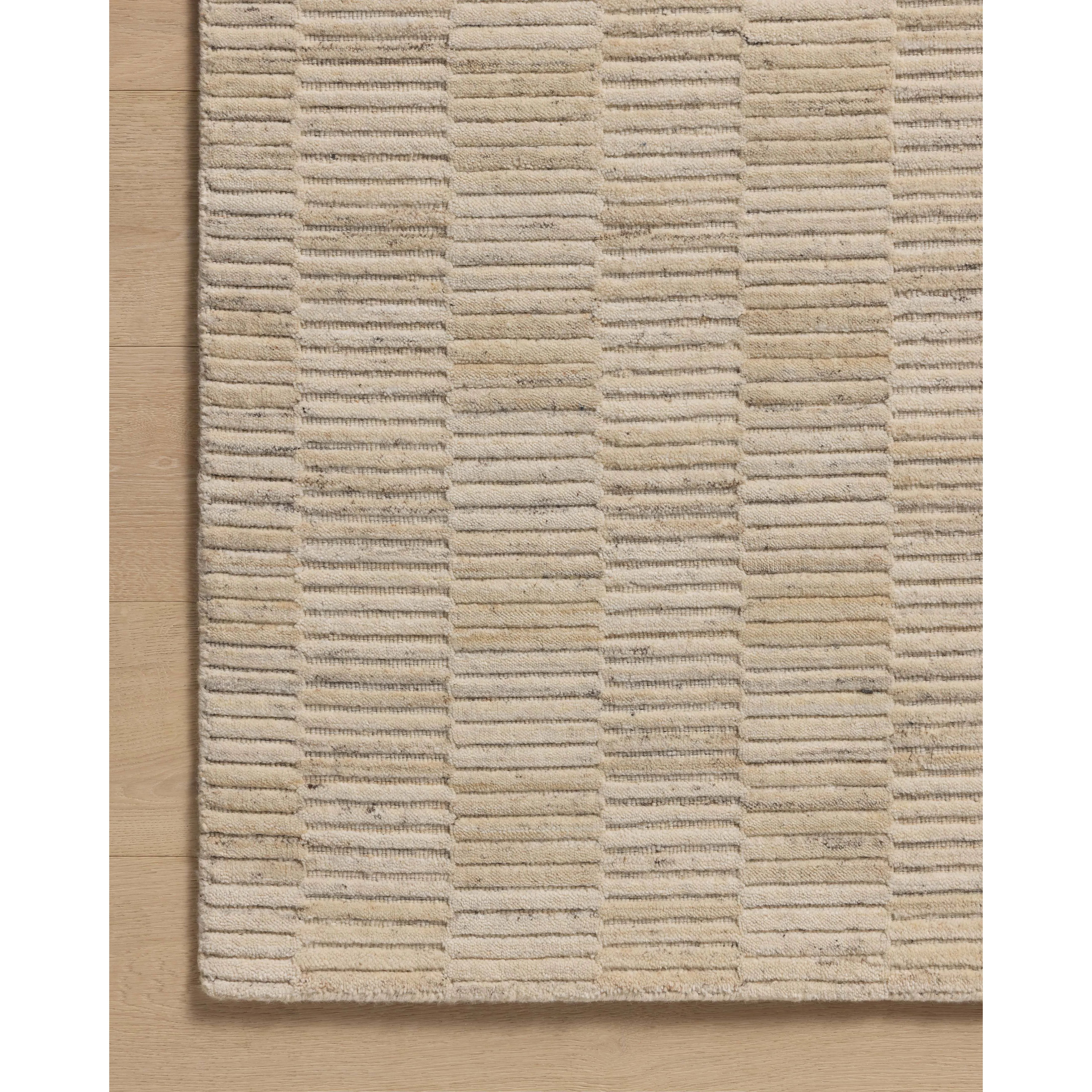 Featuring Amber Lewis x Loloi Marlowe Natural / Sand Rug by Loloi at Amethyst Home. The Marlowe Collection by Amber Lewis x Loloi is a handmade area rug with a coastal-inspired gridded design in natural color palettes. The rugs muted pattern adds understated depth with a durable, thick pile. This collection is hand-loomed of wool in India and Goodweave-certifi. Amethyst Home provides interior design, new home construction design consulting, vintage area rugs, and lighting in the Boston metro area.