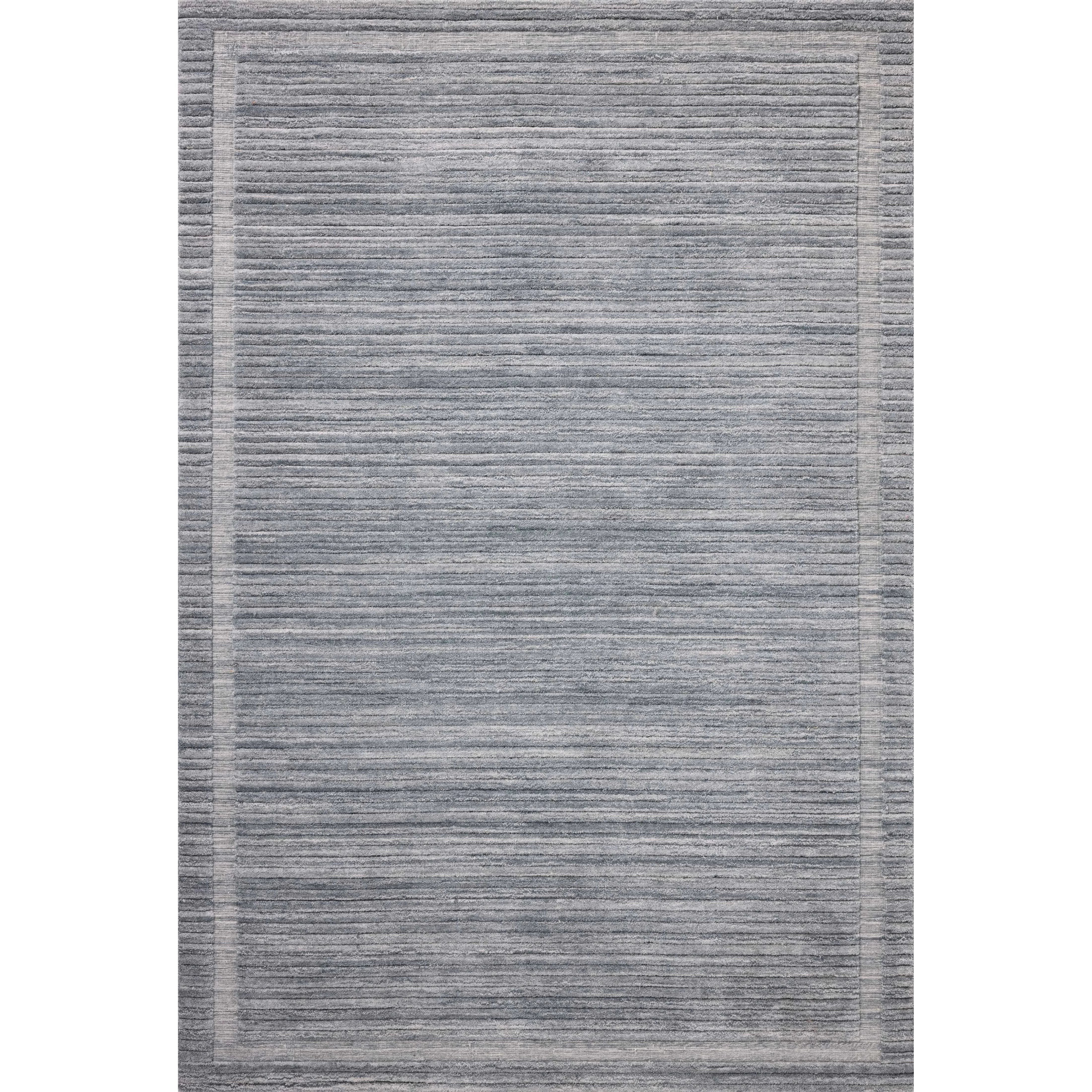 Featuring Brigette Romanek x Loloi Orly Denim Rug by Loloi at Amethyst Home. Irresistible to walk upon, the Dana Denim Rug by Brigette Romanek x Loloi has a high-low texture that alternates between a subtly shaggy pile and a soft base. Horizontal broken stripes give the area rug a fresh and energized structure, while a finish of fringe along the edges accent. Amethyst Home provides interior design, new home construction design consulting, vintage area rugs, and lighting in the Portland metro area.