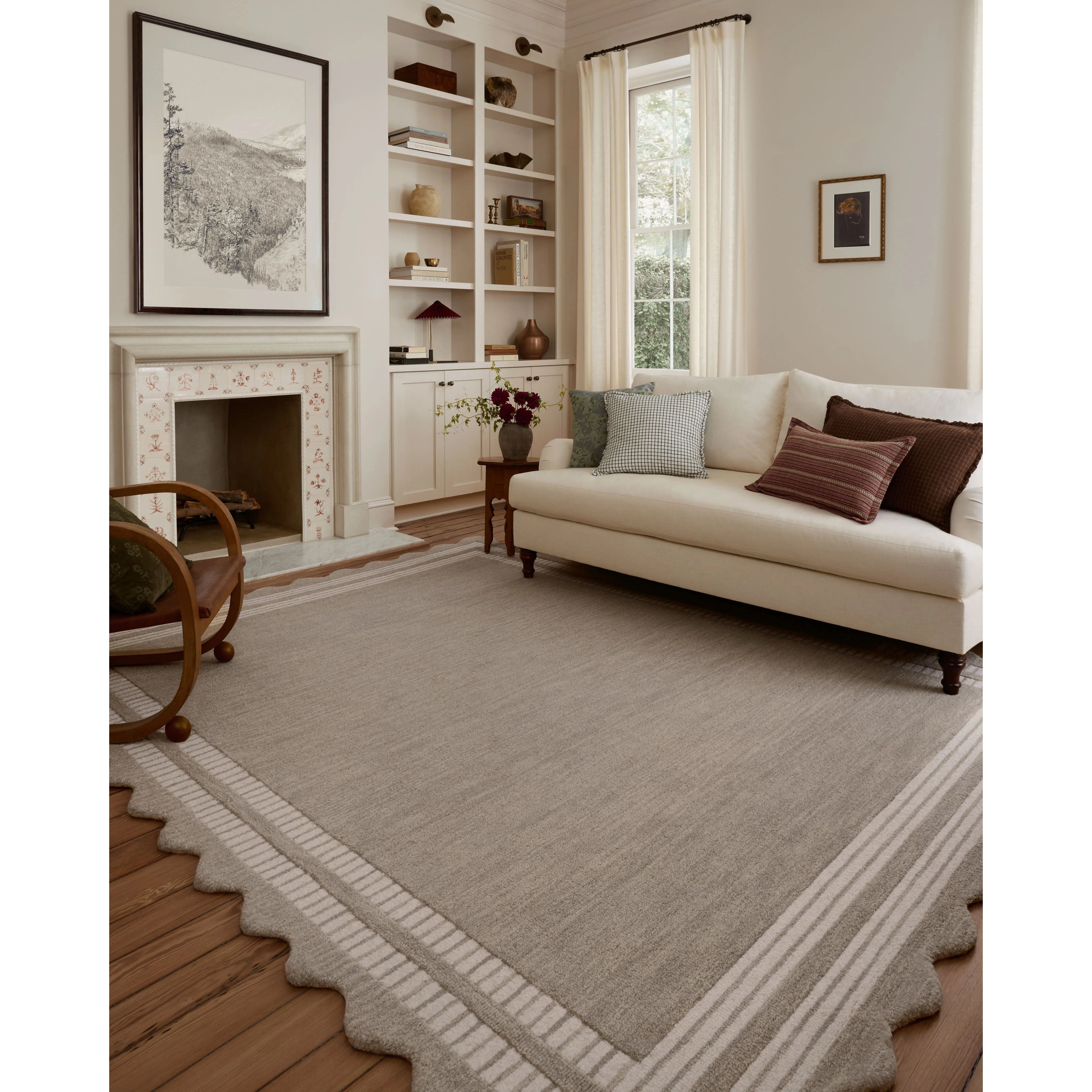 Featuring Chris Loves Julia × Loloi Scottie Fog / Ivory Rug by Loloi at Amethyst Home. The Scottie Collection from Chris Loves Julia x Loloi is a hand-tufted wool area rug with a playful scalloped edge and lower-pile, striped border for a touch of structure. The rugs overall pile is thick and plush, available in easygoing earth tones and neutral colorway. Amethyst Home provides interior design, new home construction design consulting, vintage area rugs, and lighting in the Laguna Beach metro area.