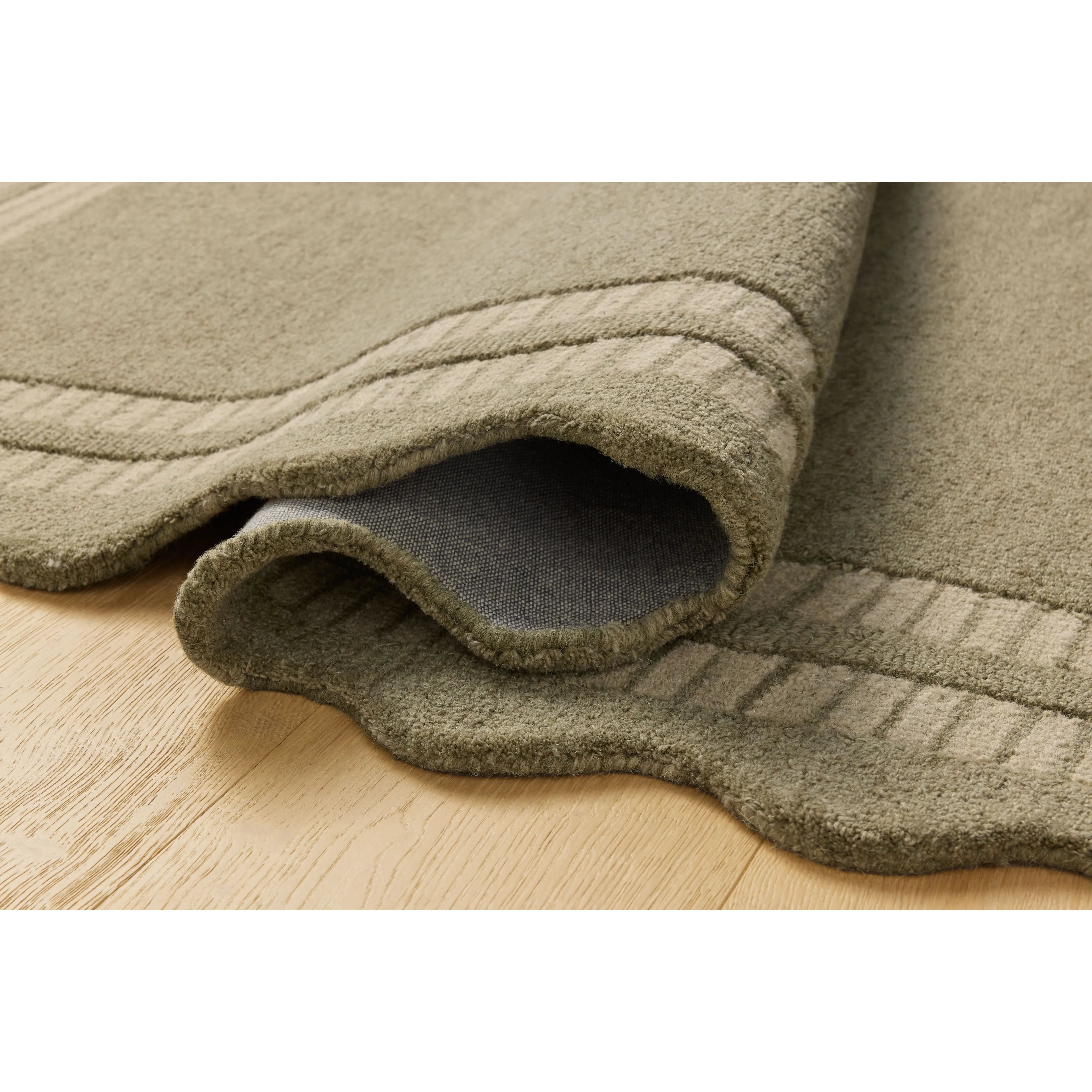 Featuring Chris Loves Julia × Loloi Scottie Olive / Pebble Rug by Loloi at Amethyst Home. The Scottie Collection from Chris Loves Julia x Loloi is a hand-tufted wool area rug with a playful scalloped edge and lower-pile, striped border for a touch of structure. The rugs overall pile is thick and plush, available in easygoing earth tones and neutral colorwa. Amethyst Home provides interior design, new home construction design consulting, vintage area rugs, and lighting in the Alpharetta metro area.