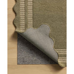 Featuring Chris Loves Julia × Loloi Scottie Olive / Pebble Rug by Loloi at Amethyst Home. The Scottie Collection from Chris Loves Julia x Loloi is a hand-tufted wool area rug with a playful scalloped edge and lower-pile, striped border for a touch of structure. The rugs overall pile is thick and plush, available in easygoing earth tones and neutral color. Amethyst Home provides interior design, new home construction design consulting, vintage area rugs, and lighting in the Laguna Beach metro area.