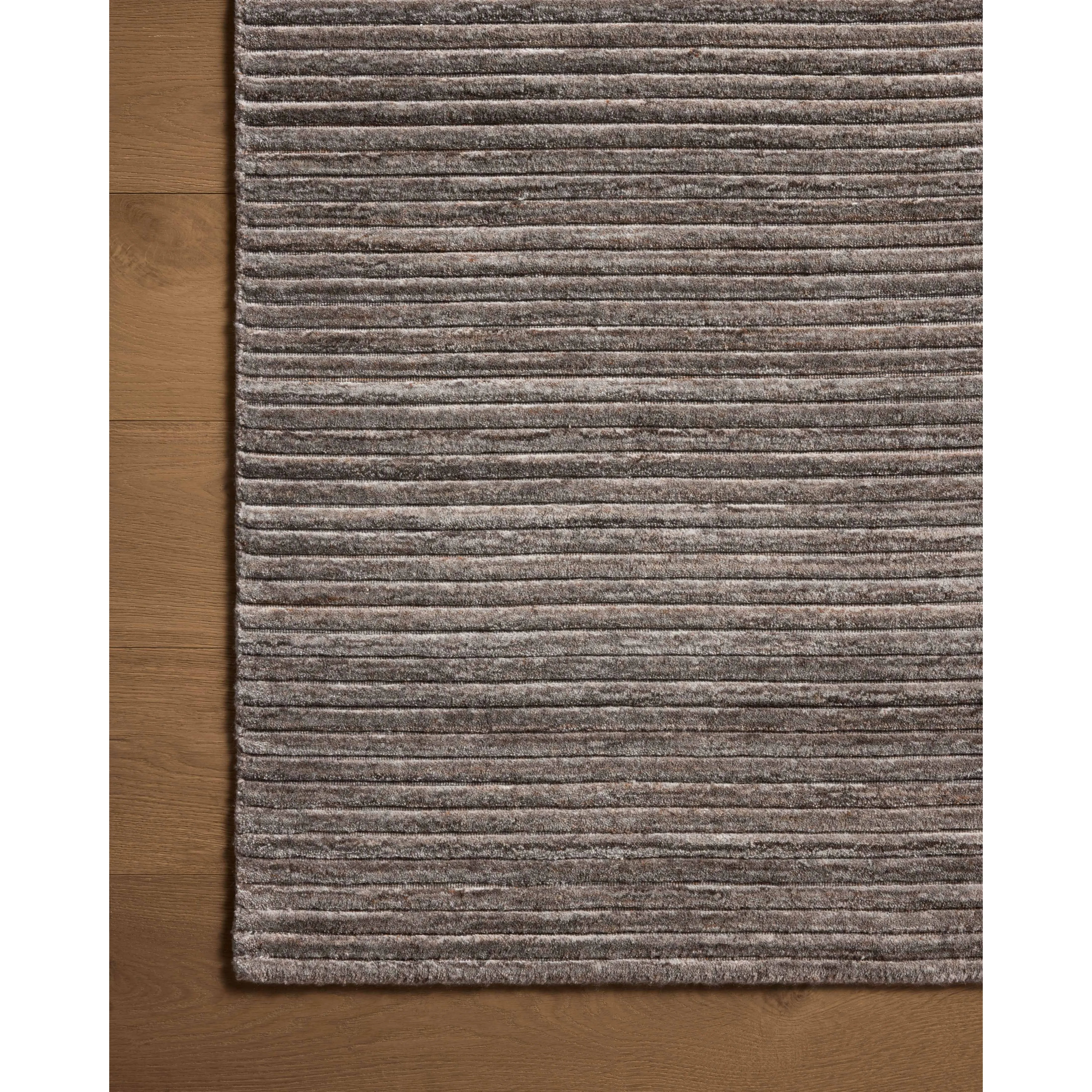 Featuring Sterling Stone Rug by Loloi at Amethyst Home. Sophisticated ribbing runs across the Sterling Collection, a nicely textured area rug with a natural color palette rich in tonality. Sterling is hand-loomed of polyester that's refreshingly easy to clean and withstands high-traffic in living rooms, dining rooms, or bedrooms. This collection is made in Ind. Amethyst Home provides interior design, new home construction design consulting, vintage area rugs, and lighting in the Boston metro area.
