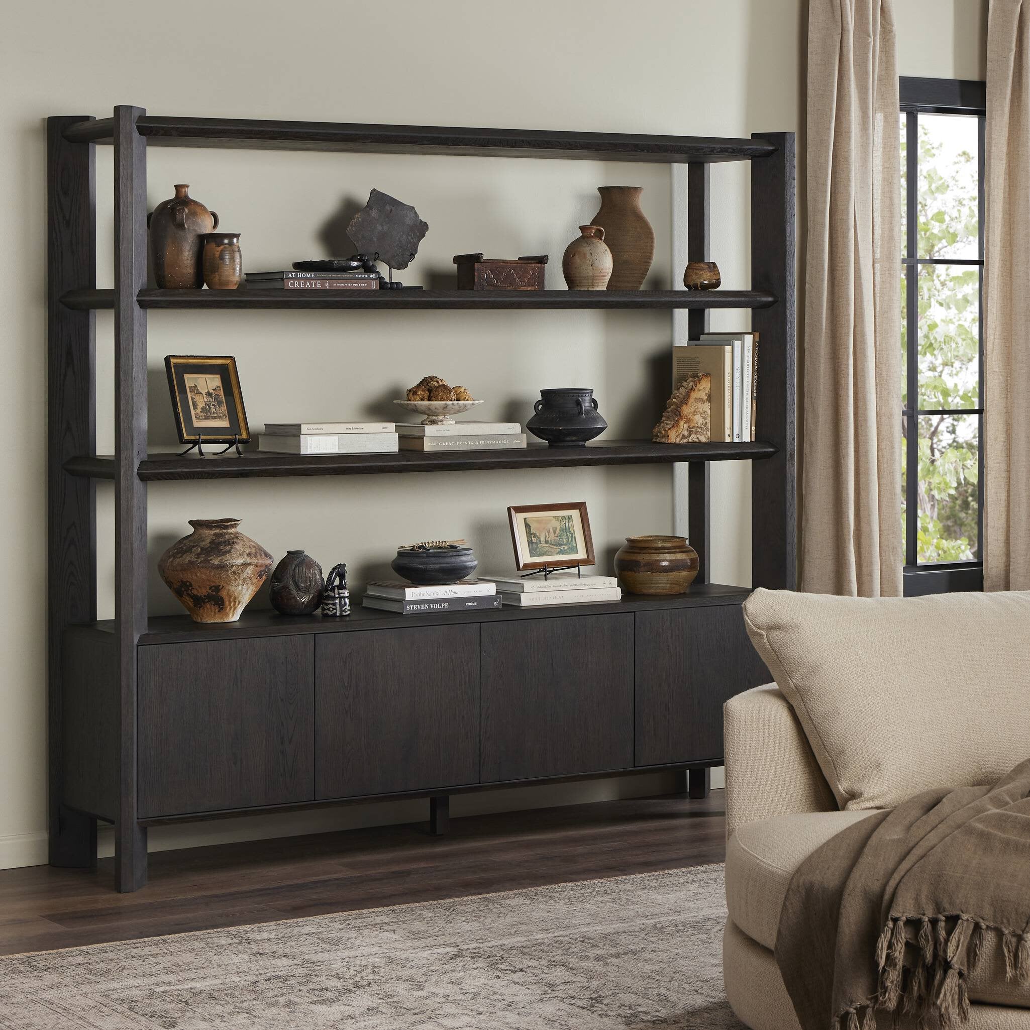 Featuring Orwin Smoked Black Oak Wide Bookshelf by Four Hands at Amethyst Home. A stunner from every angle. Crafted from a mix of solid oak and thick oak veneer, this overscale bookcase features chamfered edges along the shelves and angled outer legs for lots of movement. Finished in a smoked black oak.Overall Dimensions: 84.00"w x 18.00"d x 77.00"hWeight : 326.28 lbsMaterials : S. Amethyst Home provides interior design, new construction, custom furniture, and area rugs in the San Diego metro area