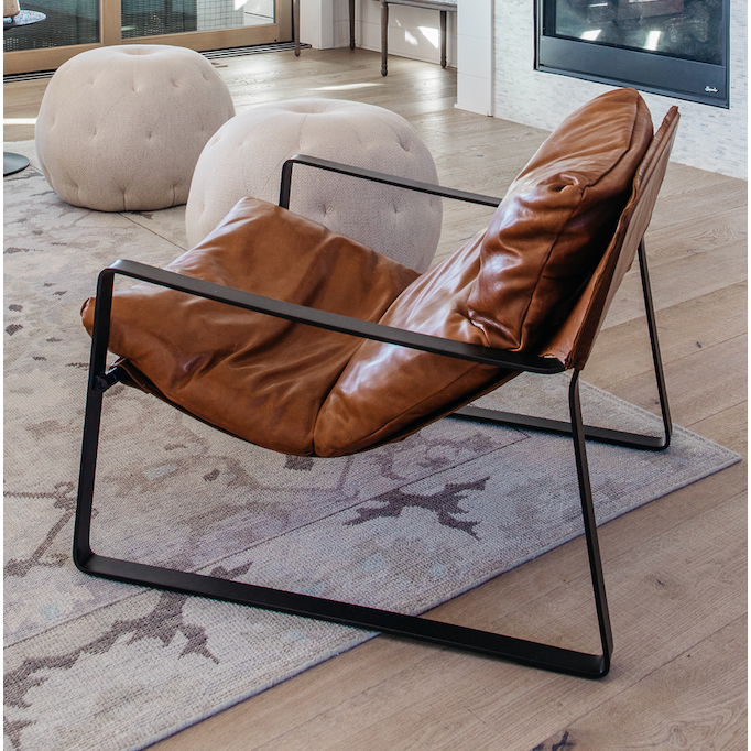 Featuring Emmett Sling Chair - Leather by Four Hands at Amethyst Home. Super stylish, effortlessly cool. Sling-style seating of tobacco-toned leather sits low and curved for a fresh take on a throwback form. Slim, gunmetal-finished iron framing ups the drama factor of an innately hip design.
Overall Dimensions: 29"W x 36"L x 29"HColors: Dakota Tobacco, Gun. Amethyst Home provides interior design, new home construction design consulting, vintage area rugs, and lighting in the Des Moines metro area.