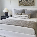 Cisco Brothers April Bed is designed and constructed in Los Angeles. The pinched edges and clean lines bring a modern, minimalist feel to any bedroom. Photographed in White Denim and Bengal Pin Striped Indigo. Amethyst Home provides interior design, new home construction design consulting, vintage area rugs, and lighting in the Newport Beach metro area.