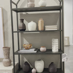 This Loomis Bookcase - Black is sleek, simple and beautifully on-trend. Black-finished iron forms an airy open frame, with an arched top for modernity in any office, living, or other space! Amethyst Home provides interior design, new home construction design consulting, vintage area rugs, and lighting in the Kansas City metro area.