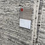 Hand-woven of 100% wool in India, the Rayan Silver Area Rug sets the tone for a calming atmosphere. Each design is crafted of textural highs and lows paired with neutral tones to create and engaging understatement. The perfect rug for your bedroom, office, or other medium traffic area.   Hand Woven 93% Wool | 5% Cotton | 2% Other Fibers Pile RAY-02 Silver