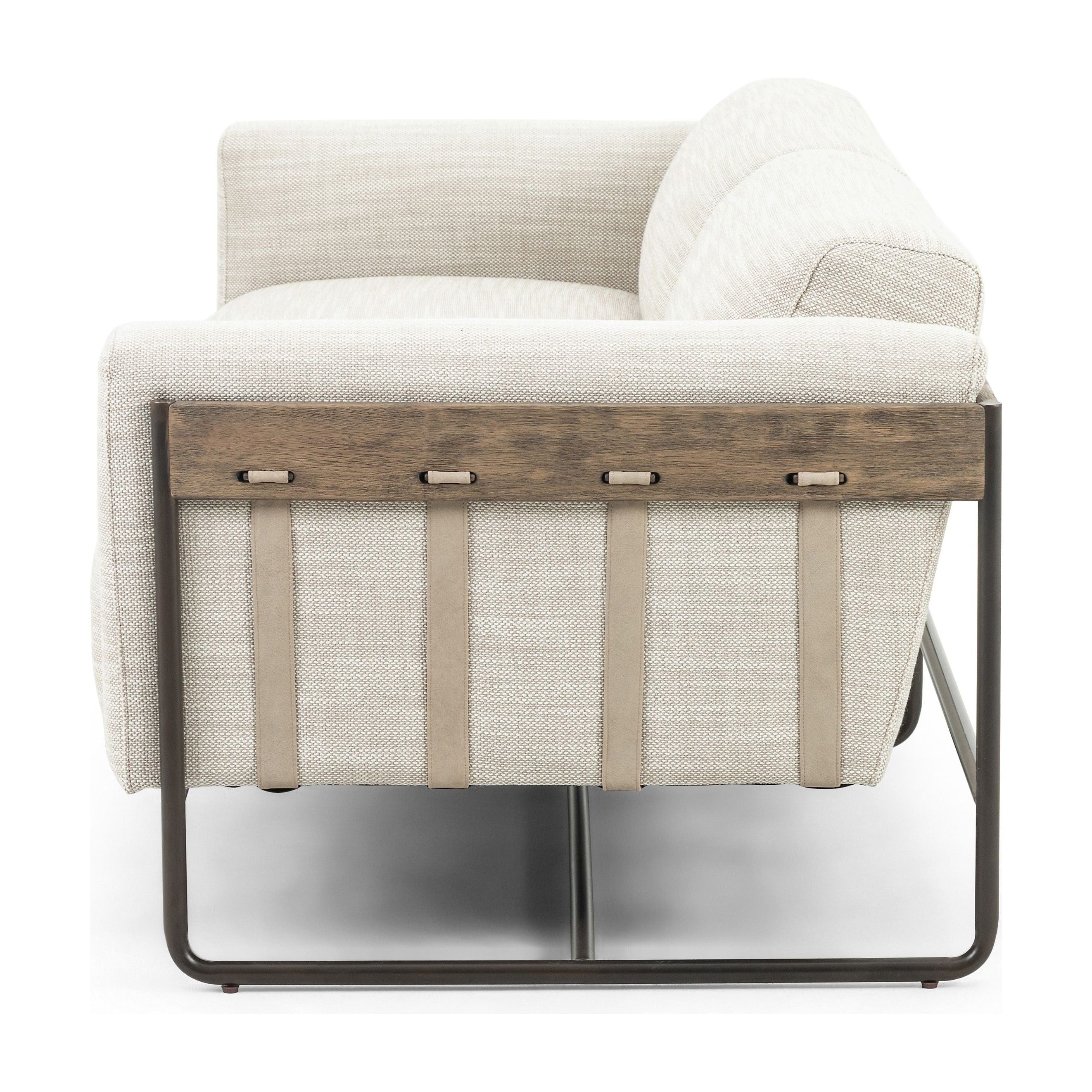 Featuring Ella 91" Sofa - Gable Taupe by Four Hands at Amethyst Home. Neutral gone novel with this Ella 91" Sofa - Gable Taupe. Taupe-colored upholstered seating is suspended by top-grain leather straps with handcrafted fastens, for an airy look. Solid rubberwood paneling wraps the frame’s entirety, while a black iron base lends lightness and contrast..  Amethyst Home provides interior design, new home construction design consulting, vintage area rugs, and lighting in the Newport Beach metro area.