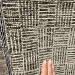 The Rize Mugler Area Rug offers intricate and delicately designed global patterns to the modern home. A thatched square motif creates an eye-catching geometric design on the artistically distressed Mugler area rug. In an earthy ivory and black colorway, this durable hand-knotted wool accent blends a timeless craft with contemporary charm.  Hand Knotted 100% Wool RIZ05