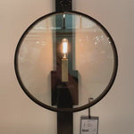 The Alice Aged Iron Sconce by Visual Comfort has a unique circular covering that showcases the single candle placed in the middle. Finished in Aged Iron, this is a gorgeous sconce to add in your living room, bedroom,  or other area needing an attractive source of light.  Designer: Suzanne Kasler