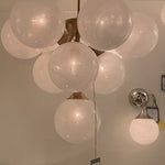 We love the white strie glass globes on this Cristol Medium Chandelier by Visual Comfort. It brings a stunning and unique look to any living room, dining room, or kitchen.   Designer: AERIN