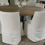 The Craig Dining Chair is featured in a gorgeous white linen slip cover in a Belgian wrinkle.   LINEN FABRIC AND BIRCH FRAME WHITE Size: 19"l x 23"d x 35"h Seat Height: 20"h