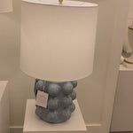 We love the form shape of this Vedra Medium Table Lamp. The dimmer feature makes it a perfect choice for your bedroom, living room, or other area that is perfect for setting the mood.   Reactive Ceramic Glazes Will Vary in Color and Texture  Designer: AERIN
