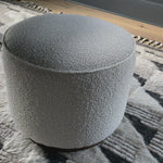 This round ottoman of textural cream boucle can be placed just about anywhere, bringing with it a hip retro vibe.  Size: 22" w x 22" d x 18.5" h  Colors: Distressed Natural, Knoll Natural Materials: Solid Parawood, 95% Polyester, 5% Pc