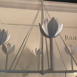 The Alberto Large Single Tier Chandelier by Visual Comfort has gorgeous, thin arms with a stunning flower placed atop each head. This gives a unique, bright look to any dining room, living room, or other large area.  Designer: Julie Neill