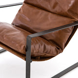 Featuring Emmett Sling Chair - Leather by Four Hands at Amethyst Home. Super stylish, effortlessly cool. Sling-style seating of tobacco-toned leather sits low and curved for a fresh take on a throwback form. Slim, gunmetal-finished iron framing ups the drama factor of an innately hip design.
Overall Dimensions: 29"W x 36"L x 29"HColors: Dakota Tobacco, G.  Amethyst Home provides interior design, new home construction design consulting, vintage area rugs, and lighting in the Los Angeles metro area.